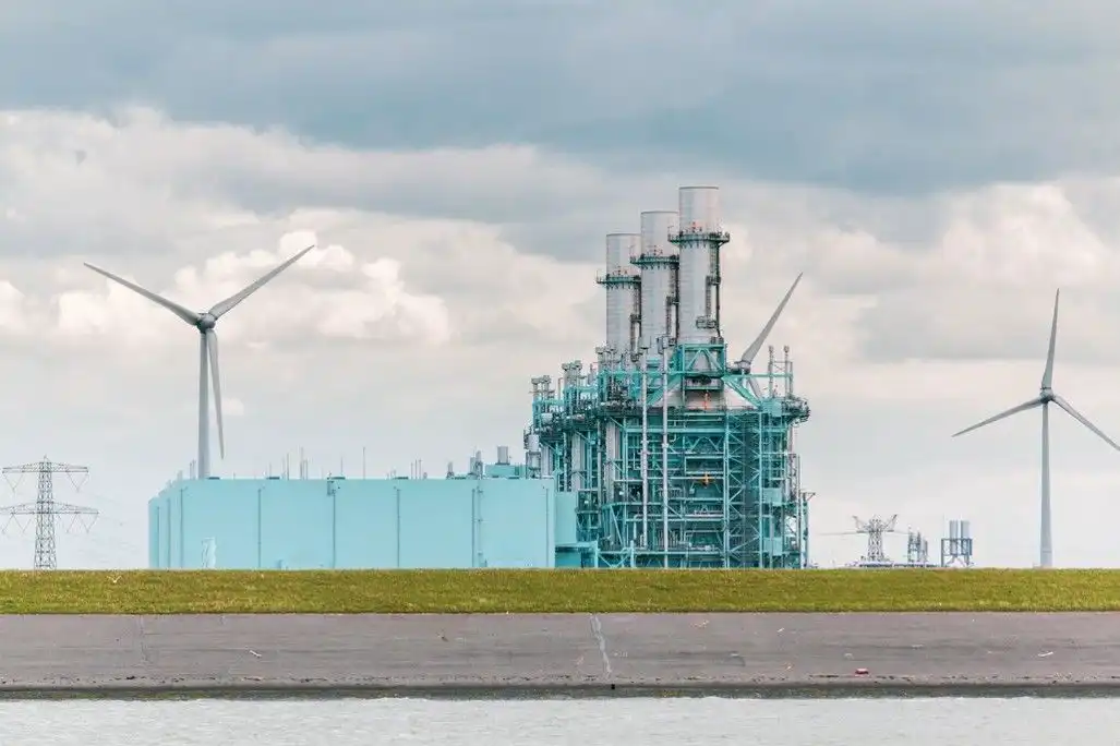 Image showing a gas power plant in front of wind turbines