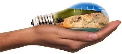 hand holding a light bulb which contains earth